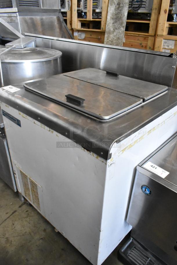 Kelvinator metal commercial chest freezer on casters, 115 volts, 1 phase. Used condition with some surface wear.