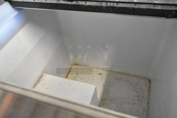 Kelvinator metal commercial chest freezer interior, showing slight wear, on commercial casters. 115 volts, 1 phase.