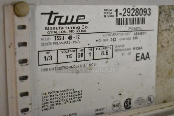 True TSSU-48-12 label detailing model, 115V, 1/3 HP, 60Hz, refrigerant R134A, EAA, NSF listed; shows usage wear.