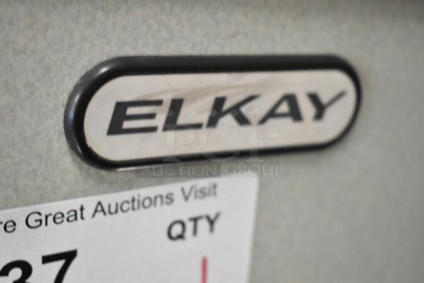 Elkay HEW3_1H metal wall mount water fountain, 115 volts, 1 phase. Close-up of Elkay logo and auction label.
