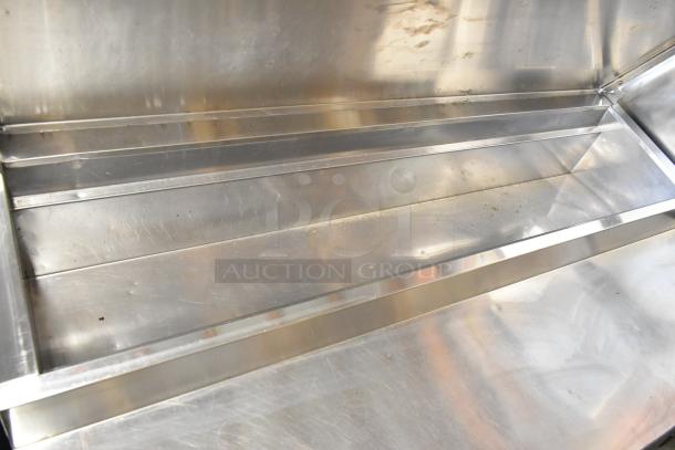 Randell 8268N stainless steel commercial pizza prep table, visible surface scratches, on commercial casters, 115V, 1 phase.