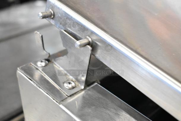 Randell 8268N stainless steel commercial pizza prep table, close-up of hinge detail, showing durable construction.