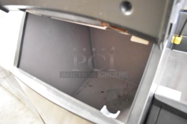 Manitowoc QY0454A stainless steel commercial ice head on a bin. 115 volts, 1 phase. Ideal for businesses. Interior condition visible.
