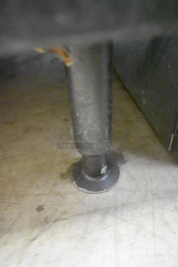 Manitowoc QY0454A ice machine leg detail, showing metal support on floor. Suitable for commercial use, 115 volts, 1 phase.