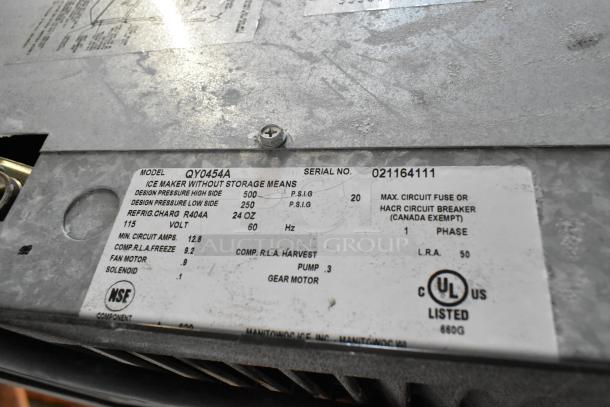 Manitowoc QY0454A commercial ice maker, stainless steel, model label visible, uses 115V, 1 phase, UL listed.