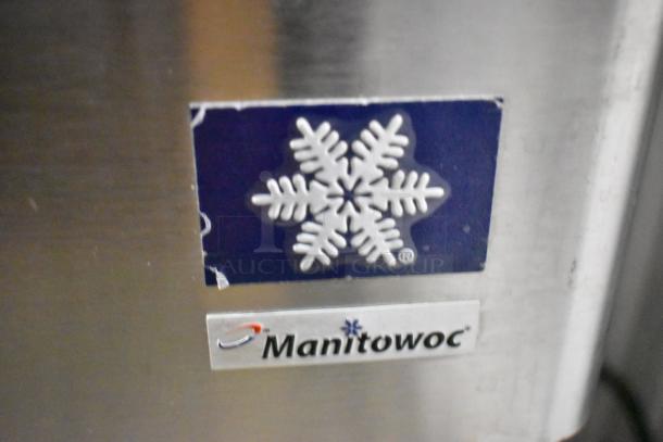 Manitowoc QY0214A ice machine, stainless steel finish, commercial model, 115 volts, 1-phase. Logo and snowflake emblem visible.