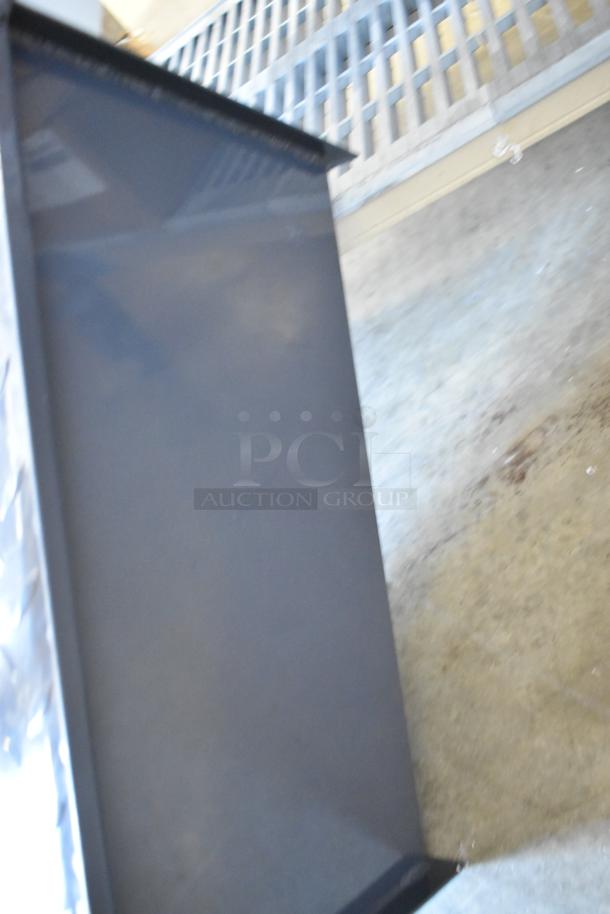 Brand new grease trap, metal construction, rectangular shape, pristine condition, suitable for commercial use.