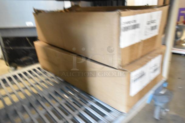 Two boxes containing brand new G11-032 C5 Wire Slides stacked on a metal shelf, boxes show barcodes and labels.