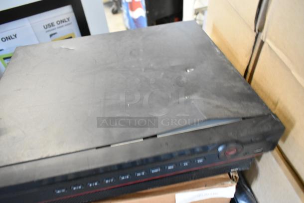 Brand new network video recorder with visible buttons and ports. Slight surface wear. Includes 4 items total.