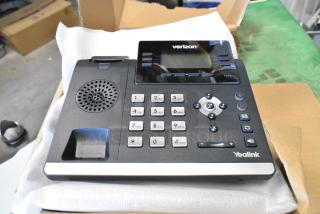 Brand new Verizon T41S IP desk phone by Yealink, showing keypad, navigation buttons, and display screen in packaging.