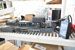 Three networking items including Cradlepoint AER2200 router and HP J9774A switch, used condition, power supplies included.