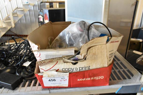 Used box of assorted items including cables and electronics, labeled "456" with auction details. Various conditions.