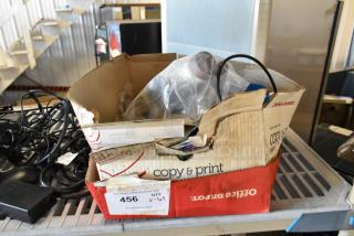 Used box of assorted items including cables and electronics, labeled "456" with auction details. Various conditions.