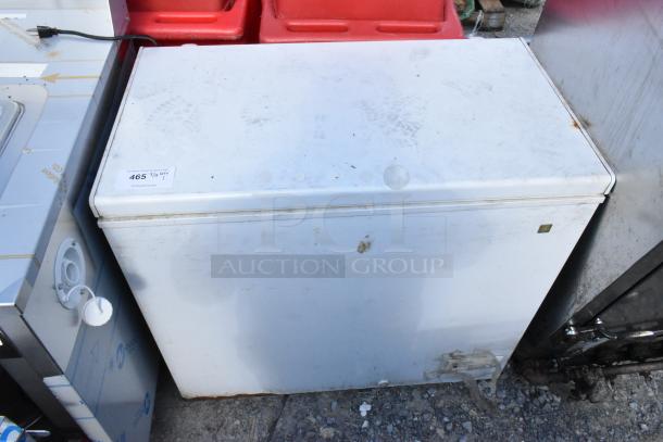 General Electric GE FCM75UBWW chest freezer, 115 volts, 1 phase; visible wear and dirt, auction tag shown.