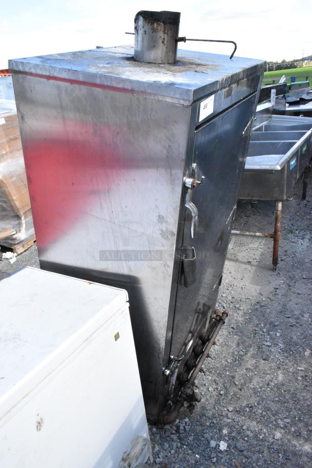 Metal commercial gas-powered vertical Chinese smoker, used condition, features a vertical design with visible gas connections.