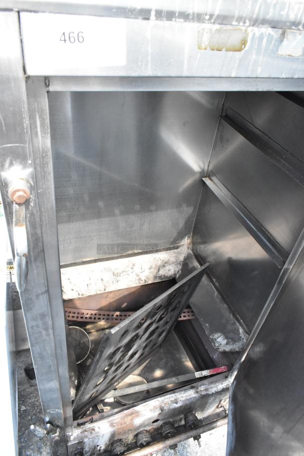 Metal commercial gas-powered vertical Chinese smoker, showing interior shelves and rust. Marked with number 466. Good condition.