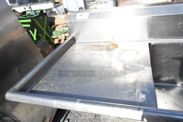 Stainless steel 3 bay sink with dual drain boards, slightly worn condition, visible rust patches, and industrial setting.
