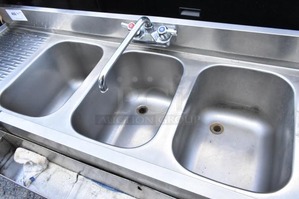 Stainless steel 3 bay back bar sink with dual drain boards and speewell, excellent condition, faucet included, price label visible.