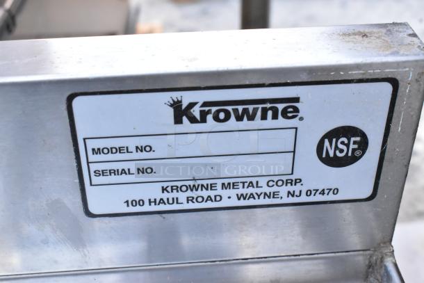 Stainless steel Krowne 3 bay back bar sink with dual drain boards, Speewell, and NSF certification label visible.