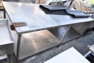 Stainless steel table with mounted commercial can opener, under shelf storage, contents, in used condition.