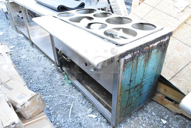 Stainless steel commercial steam table with six compartments, showing visible rust and wear. Ideal for restaurant use.