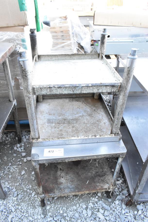Two stainless steel equipment stands with undershelf, visibly rusted, showing tag "472". Suitable for industrial use.