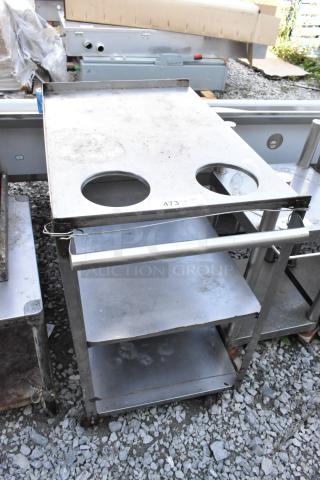 Metal 3-tier cart on commercial casters with cutouts on top, moderate wear, and labeled "473."