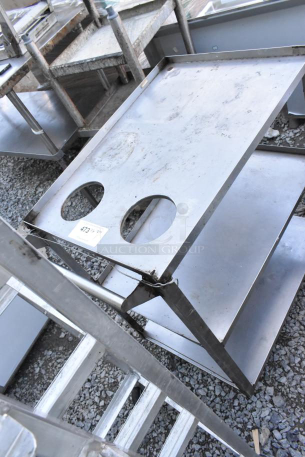 Metal 3 tier cart with commercial casters, visible wear, includes two circular cutouts, auction tag labeled "473."