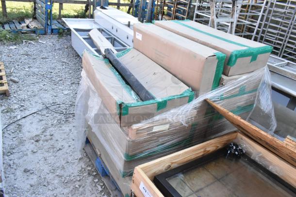 Twelve new boxes of Quantum 1836P wire shelves, wrapped on a pallet, ready for auction.