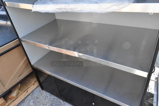 BRAND NEW SCRATCH AND DENT shelving unit with two metal shelves and black base cabinets. Visible minor surface marks.