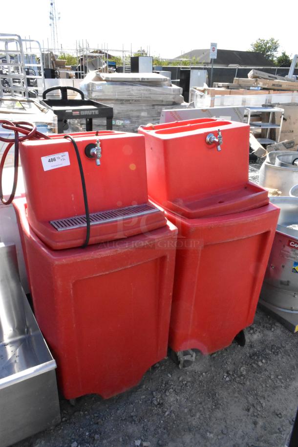 Two red poly single tap dispensing systems on commercial casters. Visible tag: “486.” Used condition.