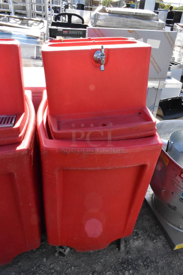 2 red poly single tap dispensing systems on commercial casters, slightly worn, ideal for events or commercial use.