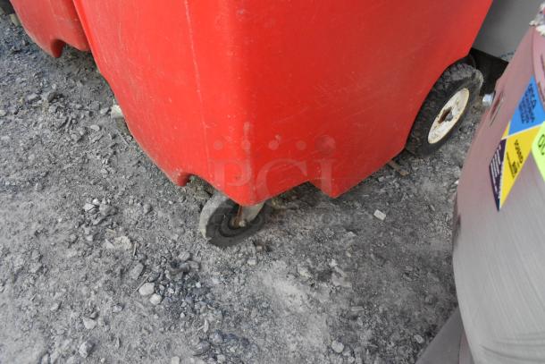 2 Red Poly Single Tap Dispensing Systems on commercial casters, showing wear. Durable, mobile units for efficient dispensing.