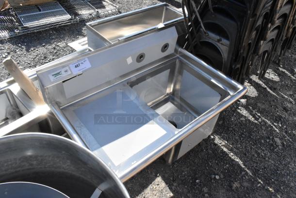Brand new Regency 600S1181818L stainless steel single bay sink with left side drain board, visible minor scratches, no legs.
