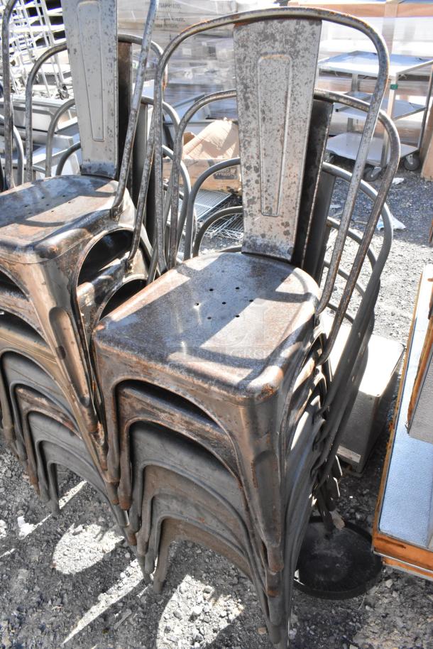 19 new metal Tolix style chairs with scratch and dent condition, stackable design, durable industrial look.