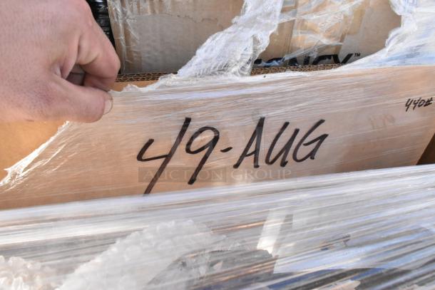 Plastic-wrapped box labeled "49-AUG," containing 18 brand new scratch and dent items. Hand peeling back wrap.