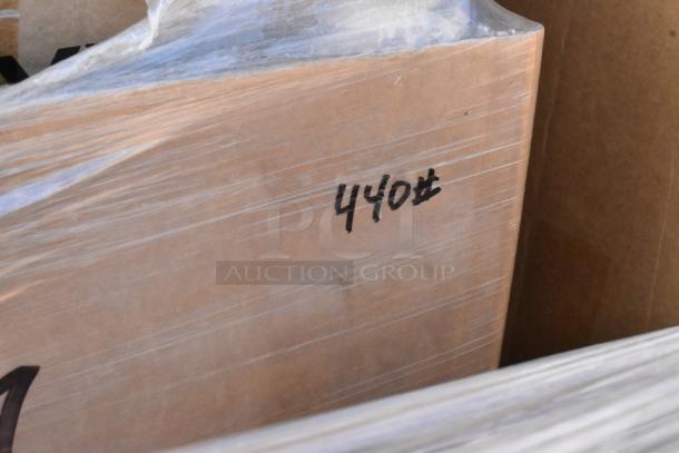 Stack of 18 brand new scratch and dent items, wrapped for auction. Visible marking: "440#" indicates weight.