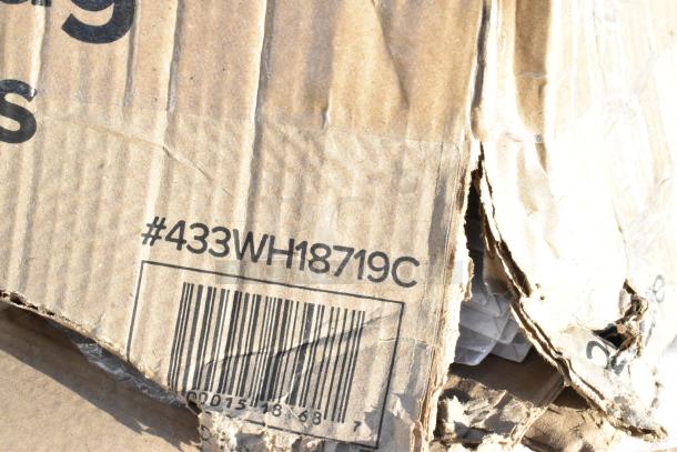 Damaged cardboard box labeled "#433WH18719C," containing 5 new scratch and dent items, including a Winco pancake dispenser.