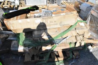 Six-pack stainless steel work tables and pot rack, brand new with scratches and dents, Regency labels visible on boxes.