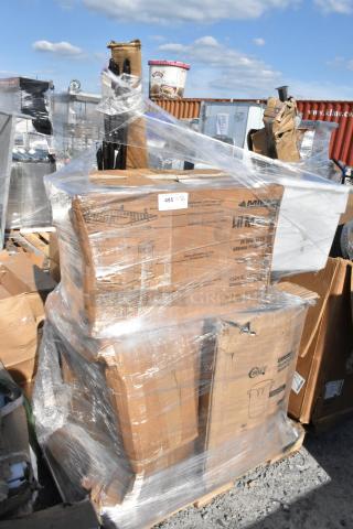 Pallet of boxed items wrapped in plastic, including various household goods. Labels indicate new and slightly damaged condition.