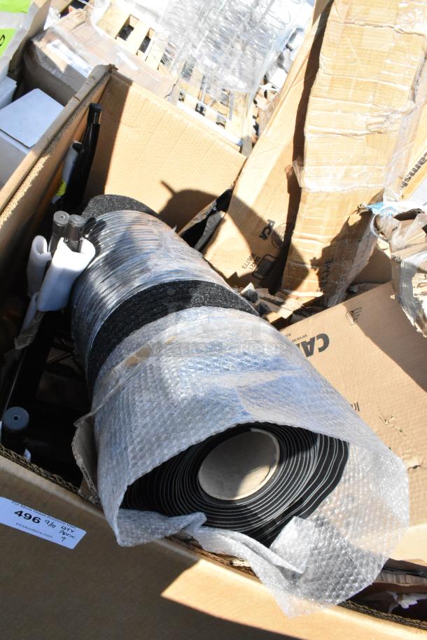 Boxed scratch and dent items including a Cambro Dunnage Rack. Wrapped and packed, new condition visible. Label reads "496".