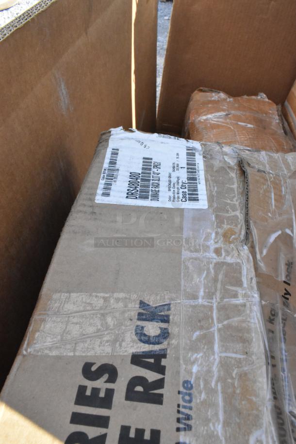 Box labeled "DINNERWARE RACK, LOT 87" in shipping condition. Part of 7 new scratch and dent items, includes Fetco and Regency products.