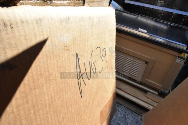 Cardboard box marked "AUG39" containing auction items, including Fetco coffee dispenser and Regency sink, scratch and dent.