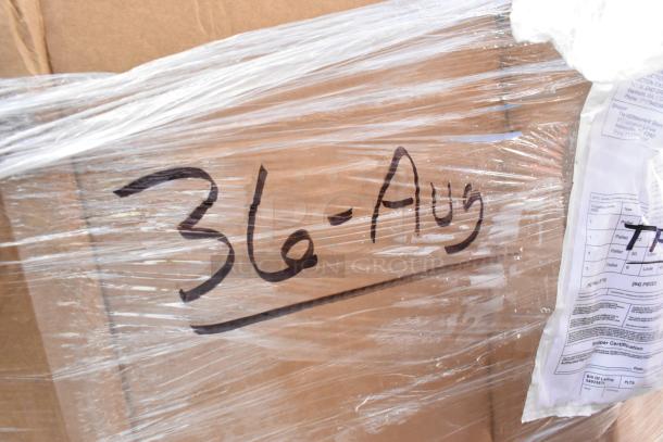 Pallet wrapped in plastic showing handwritten "3A-Aug" and attached shipping documents, containing auction items.