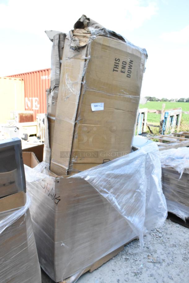 Torn cardboard boxes marked "This End Down," presumed to contain new scratch and dent items, wrapped in plastic.
