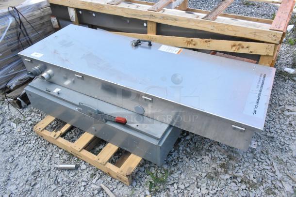 Metal power distribution box on pallet, includes wiring ports, latch, and label indicating "Power Distribution Equipment Co., Inc."