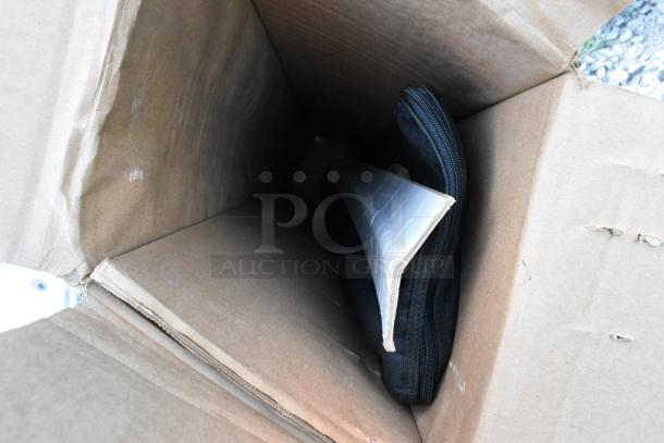 Open box containing three items, including a power box and a black zipper pouch. Items appear in good condition.