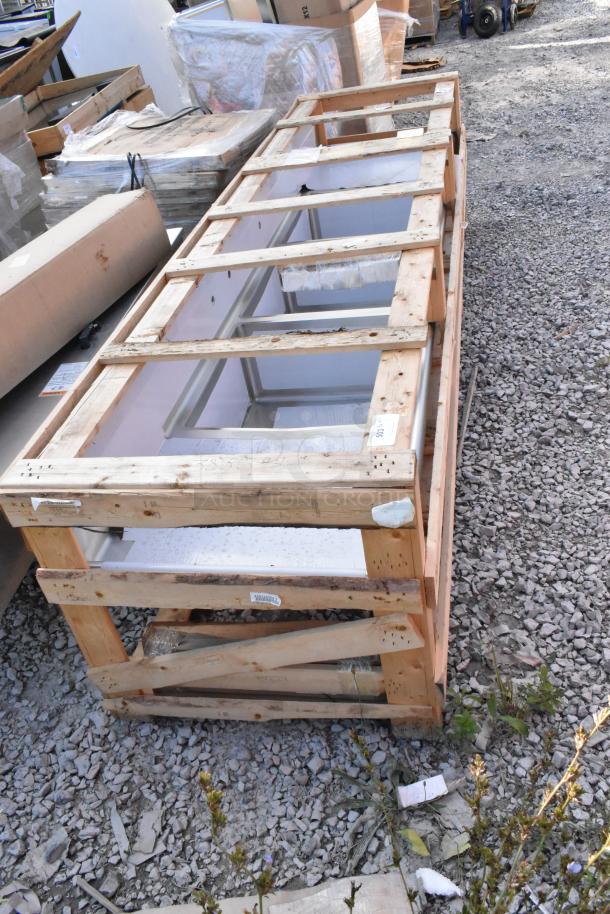 Alt text: 2024 Elkay stainless steel 3 bay sink with dual drain boards in crate. Brand new, minor scratches and dents visible.