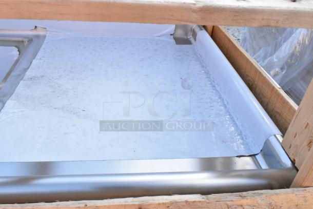 Brand new 2024 Elkay stainless steel 3 bay sink with dual drain boards, scratch and dent condition, protective wrap visible.
