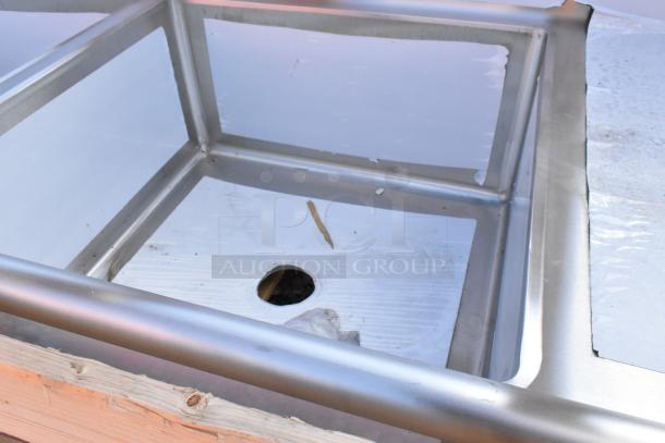 2024 Elkay stainless steel 3-bay sink with dual drain boards. Brand new, minor scratches and dents visible.